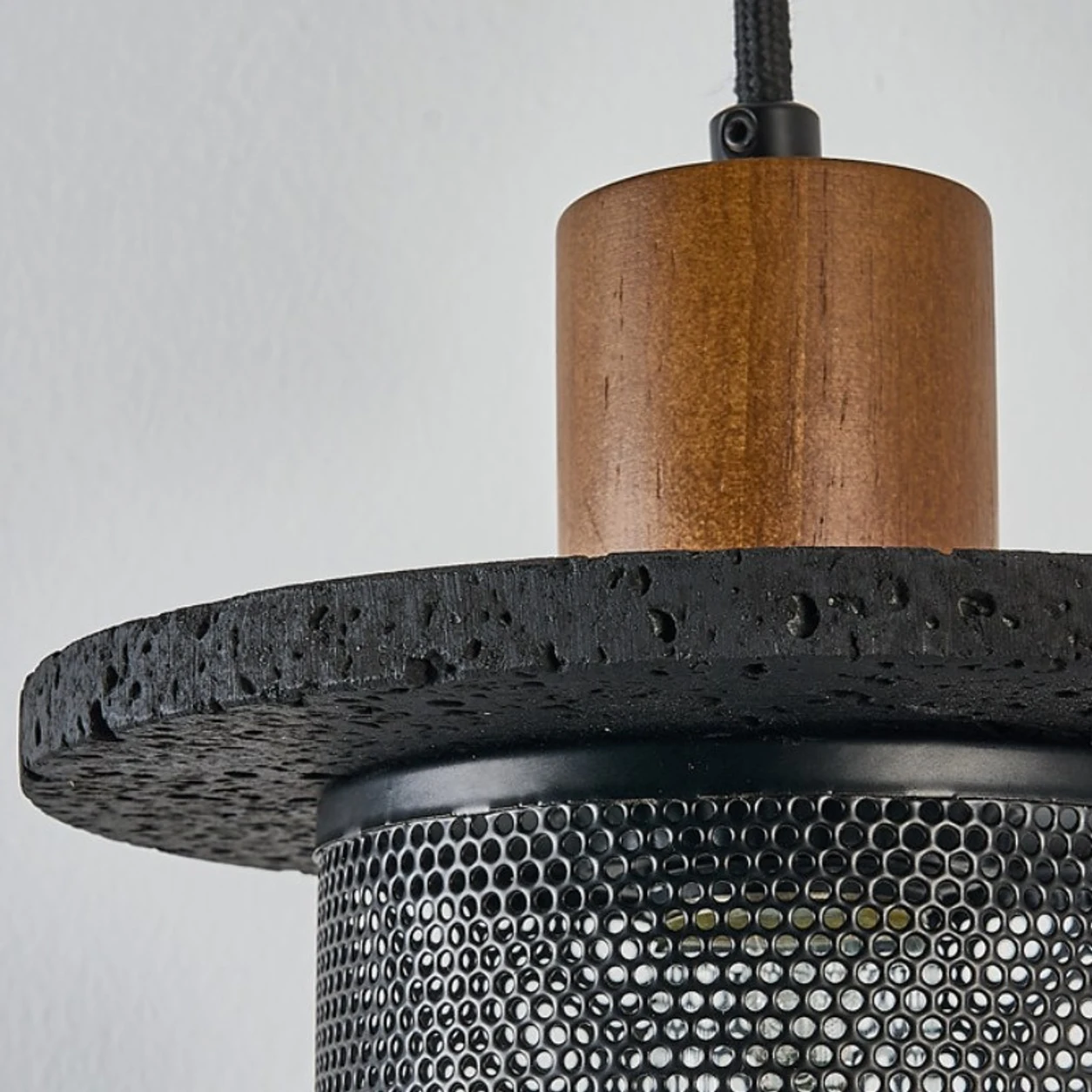 Close detail of the wood cap and black mesh shade connection