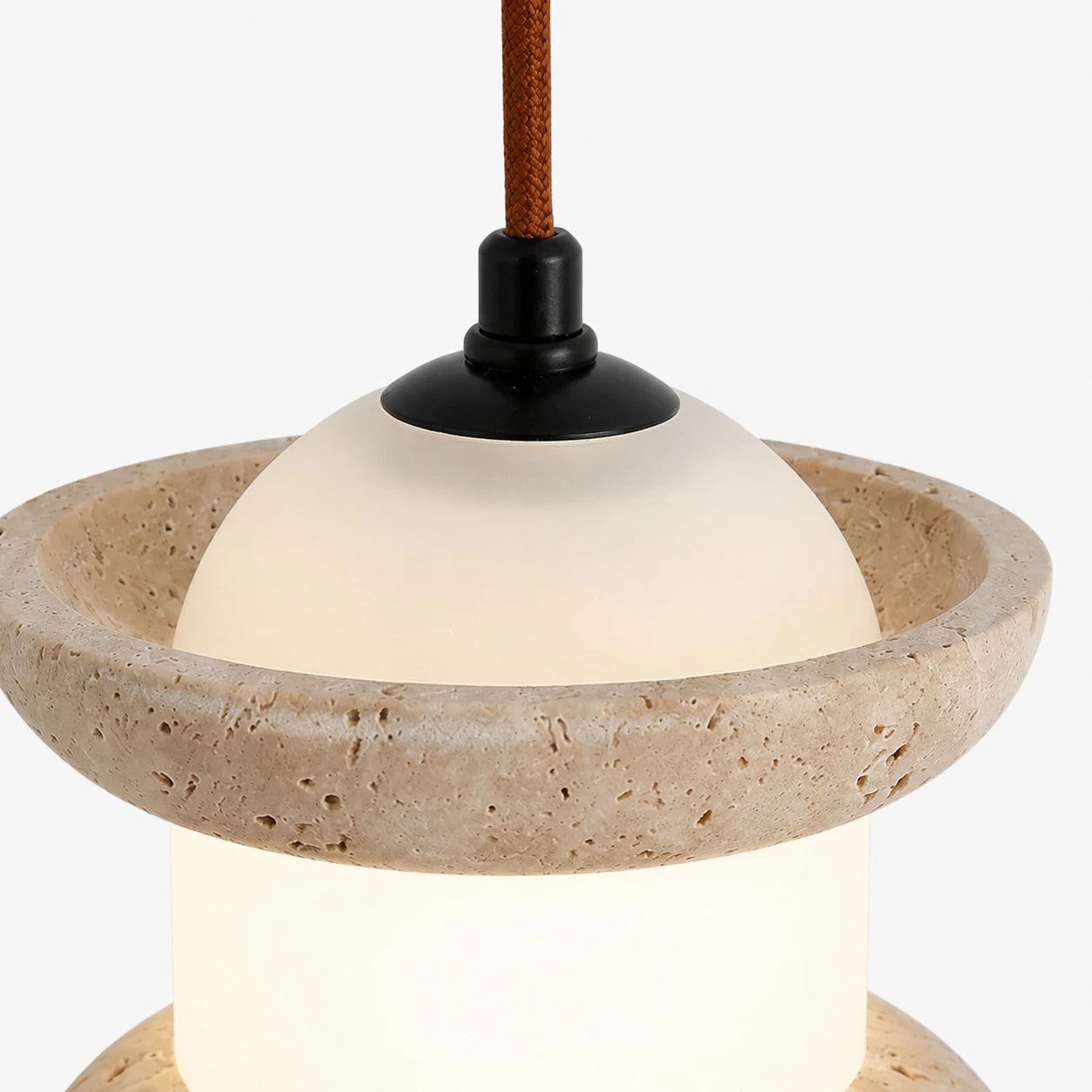 Close view of travertine stone pendant light with warm LED glow